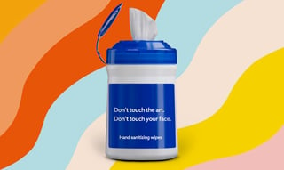 A container of cleansing wipes that says 